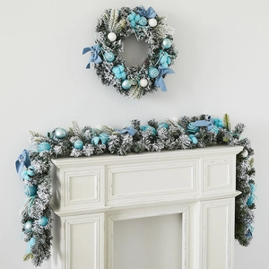 Christmas wreath and garland set in blue and white colors displayed on a white fireplace