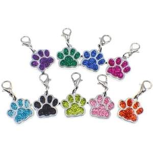 Macro view of nine colorful glitter paw pendants with metal lobster clasps for bags