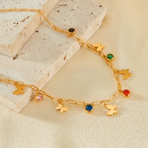 Colorful zircon butterfly necklace in stainless steel on silk background