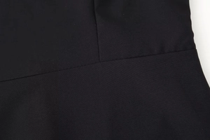 Close-up of the seam and fine fabric texture on a black off-shoulder strapless dress