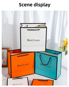 Detailed shot of three colorful paper gift bags with Best Love print and woven handles