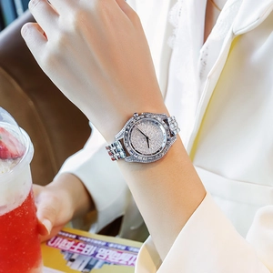 Close-up of luxury silver quartz watch for women with full diamond pavé on dial and band