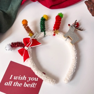 Detail of plush Christmas headband with colorful candle shapes and reindeer decoration