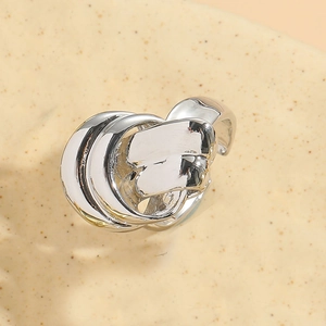 Macro shot of silver knot ring showing intricate twisted design and polished finish