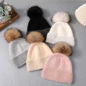 Women's warm winter beanie hats with raccoon fur pom poms and rhinestone details