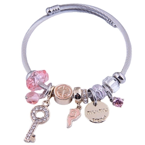 Silver steel cable bracelet with pink charms, key pendant and sparkling crystals