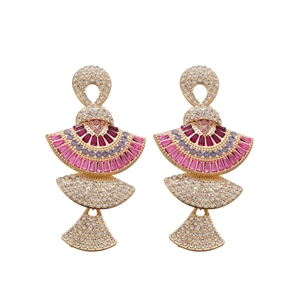 Luxurious fan-shaped gold earrings set with sparkling pink and purple crystals on white base