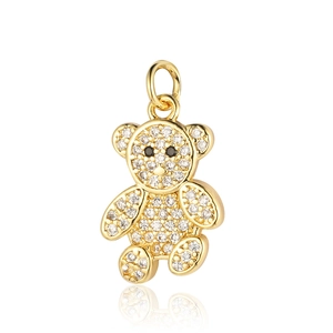 Detailed close-up of a golden teddy bear charm pendant inlaid with sparkling crystals