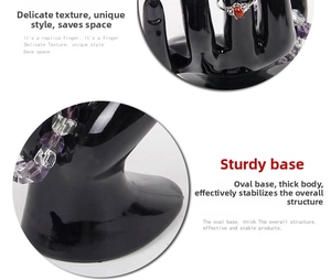 Detail view of black resin hand mannequin display showing steady oval base for jewelry