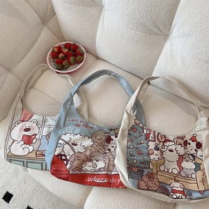 Three canvas tote bags with cute cartoon bear prints arranged on a cozy soft white sofa