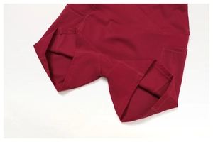 Close-up of burgundy yoga shorts showing side pockets and gusseted crotch stitching
