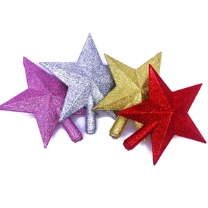 Glittering Christmas tree star toppers in gold silver red and purple on white background