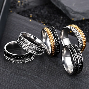 Men's stainless steel rotatable chain rings in silver, gold and black on stone background