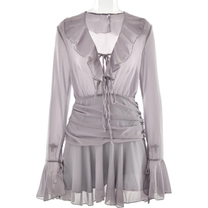 Detail of grey chiffon V-neck dress featuring ruffle trims and delicate tie neck details