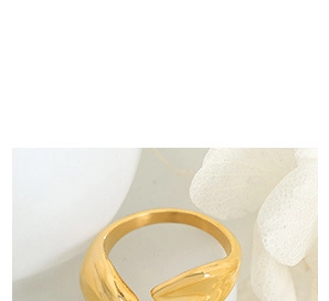 Close-up of golden irregular open ring with elegant organic flowing lines design