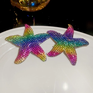 Detailed close-up of starfish drop earrings with colorful gradient rainbow rhinestones