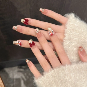 Detail view of 3D lion dance and red bow on festive cat eye press-on nails
