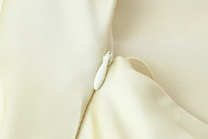 Detailed close-up of high-quality invisible zipper on a satin texture halter dress