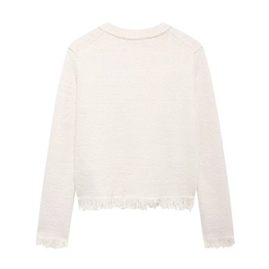 Close-up of white knit cardigan back featuring elegant fringe hem and soft wool texture