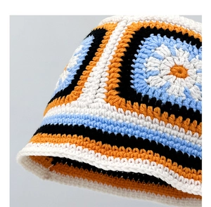 Close-up of handmade crochet bucket hat featuring colorful sunflower pattern and stripes