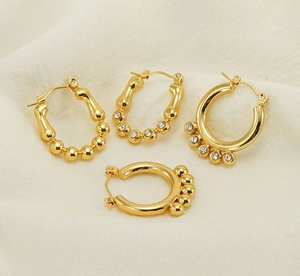 Detail view of gold geometric hoop earrings with pearls and crystal rhinestones