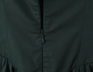 Detail view showing a dark green dress back with invisible zipper and pleated texture