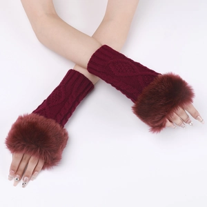 Detail view of burgundy cable knit arm warmers featuring fluffy faux fur cuffs