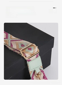 Detail of adjustable bohemian woven shoulder strap with gold metal buckle and geometric pattern