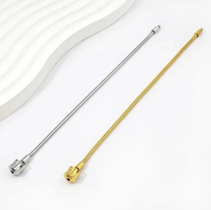 Close-up of gold and silver snake bone chains with cylindrical clasps for DIY jewelry