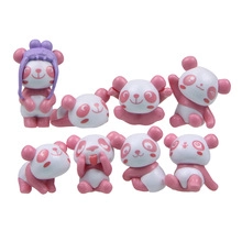 Set of eight miniature pink and white panda figurines in various playful poses