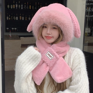 Close-up of pink rabbit ear plush hat and scarf combo with soft faux fur texture