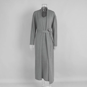Detail of grey knitted two-piece set showing soft fabric texture of cardigan and maxi dress