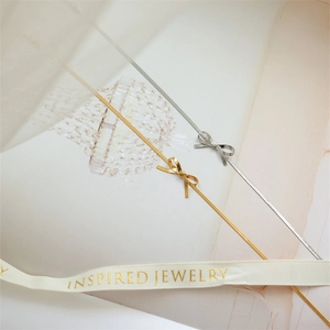Elegant gold and silver bow pendant necklaces on stylish snake chains for women