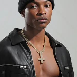 Close-up of hip hop iced out inverted cross pendant with golden cuban link chain