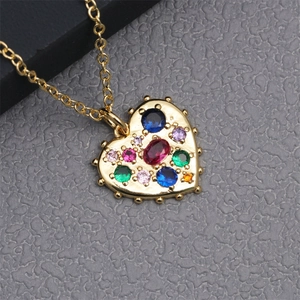Close-up of golden heart pendant necklace featuring vibrant multi-colored gemstones