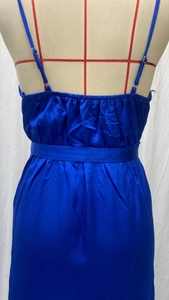 Detail of royal blue satin evening dress showing the back straps and pleated fabric texture
