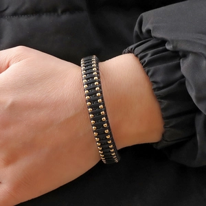 Men's hand-woven microfiber bracelet with gold stainless steel studs and dual-tone finish