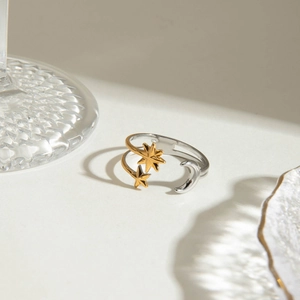 Minimalist 18K gold and silver steel ring featuring celestial star and moon open design