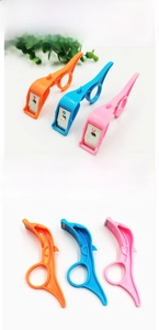Three-piece ring-style fruit peelers in orange, blue, and pink colors with finger grips