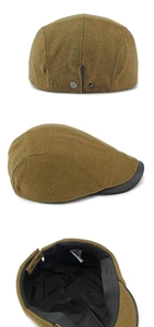 Detail of wool ivy cap featuring leather brim and adjustable metal snap buckle