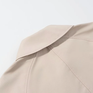 Detail of lapel collar and shoulder stitching on khaki twill cropped trench coat