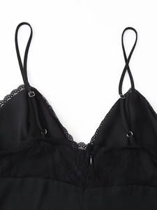 Detail of black satin camisole dress with delicate lace trim and adjustable thin straps