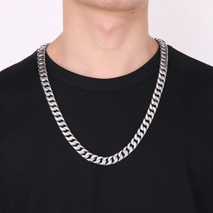 Silver 12mm stainless steel Cuban chain necklace worn on neck over black t-shirt