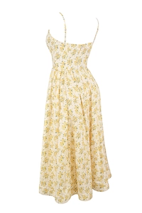 Detail of floral midi dress featuring thin spaghetti straps and an open back design