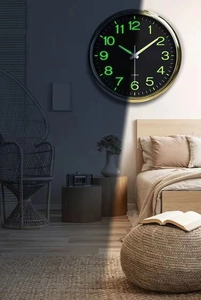 Detailed day and night contrast showing luminous green quartz clock hands and numbers
