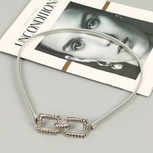 Detailed view of silver elastic snake chain metal belt with interlocking rectangle buckles