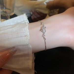 Close-up of a silver heart bracelet with zircons and an adjustable pull-tab clasp