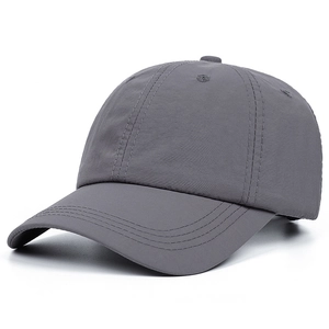 Close-up of a dark grey baseball cap showing textured fabric and curved brim stitching
