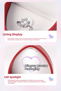 Macro shot of red heart jewelry box with LED spotlight and soft velvet interior