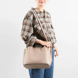 Minimalist taupe PU leather crossbody bag with adjustable strap and gold logo detail
